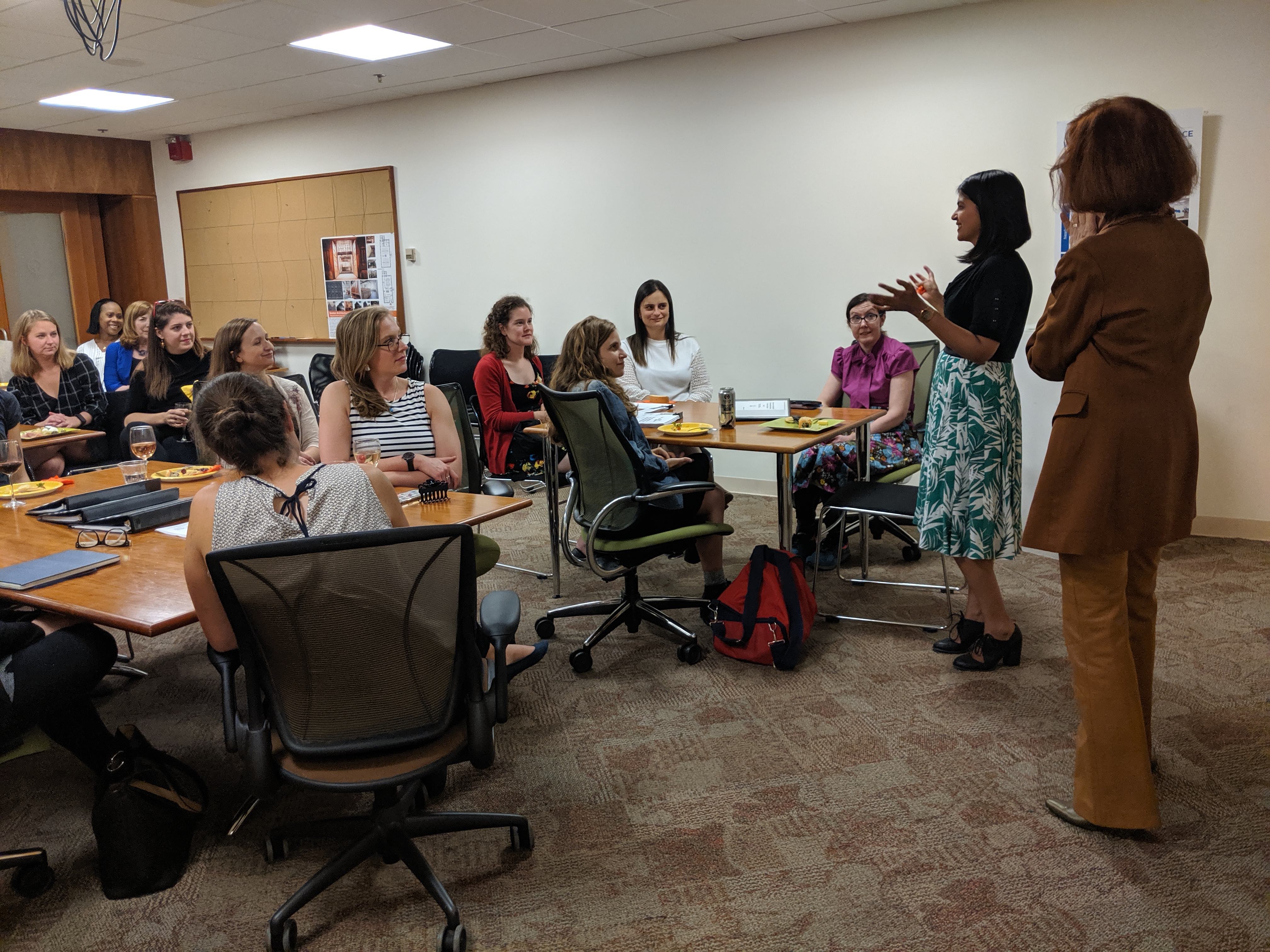 IHCD Executive Director Valerie Fletcher and coop student Mary Joseph introduce themselves to the guests in the IHCD conference room