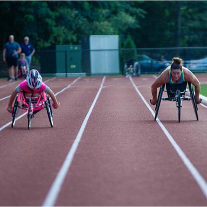 Maddie Wilson and her mentor, champion wheelchair racer, Tatyana McFadden at the race track