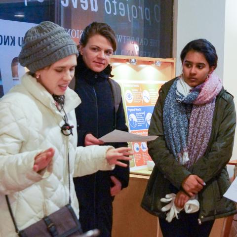 IHCD staff and a participant look on as a user/expert shares her experience during the Challenge: Design event.